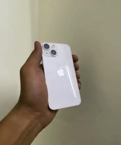 Rear view of a PTA approved Starlight White iPhone 13 mini held in hand showing the diagonal dual-camera layout and glossy glass back.