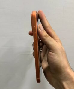 Left side profile of a copper orange iPhone 17 Pro max displaying the Action button and volume controls.