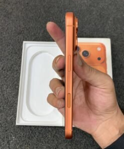 Right side edge of a copper orange iPhone 17 Pro held in hand, showing the power button and flush Camera Control sensor.