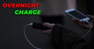 iPhone charging overnight with a cable connected to a power bank in a dark room