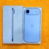 Rear view of a Sky Blue iPhone 17 Air non pta resting in its retail packaging box, displaying the single rear lens on a horizontal camera bar island.