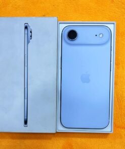 Rear view of a Sky Blue iPhone 17 Air non pta resting in its retail packaging box, displaying the single rear lens on a horizontal camera bar island.