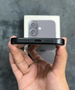 Bottom edge view of a Black iPhone 17 highlighting the USB-C charging port, dual speaker grilles, and bottom frame finish.