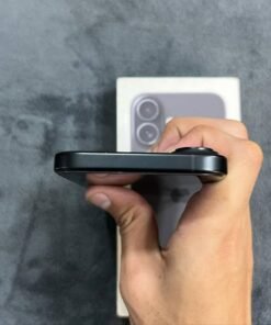Top edge view of a Black iPhone 17 showing the smooth matte aluminum frame finish and camera bump offset.